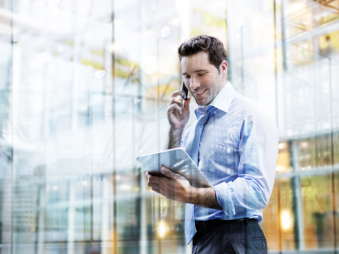 Business man using phone and Digital Tablet